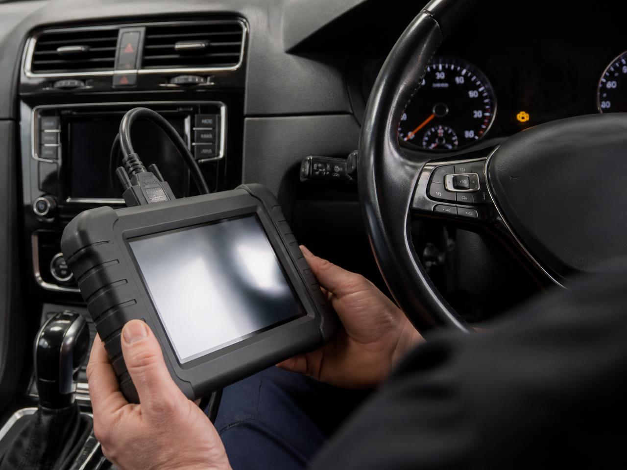Diagnostic scan tool connected to a car dashboard